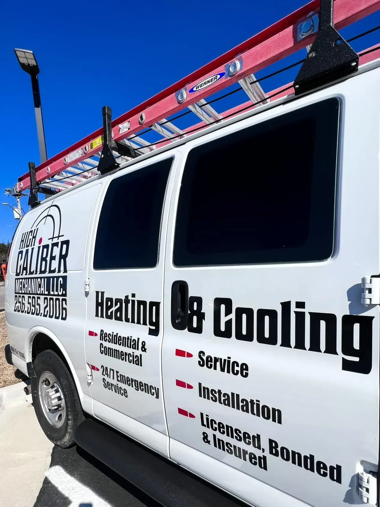 A white van that says heating and cooling on it