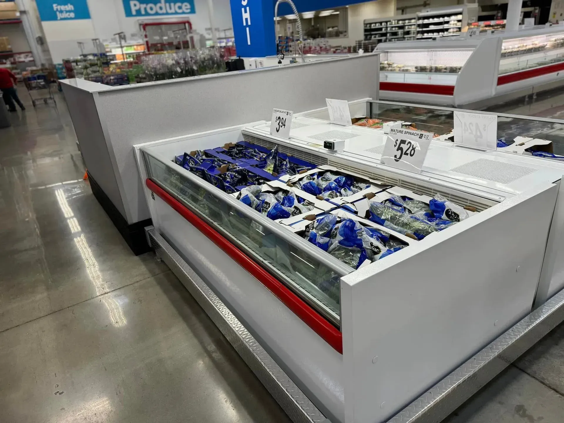 A produce section of a grocery store with a sign that says produce