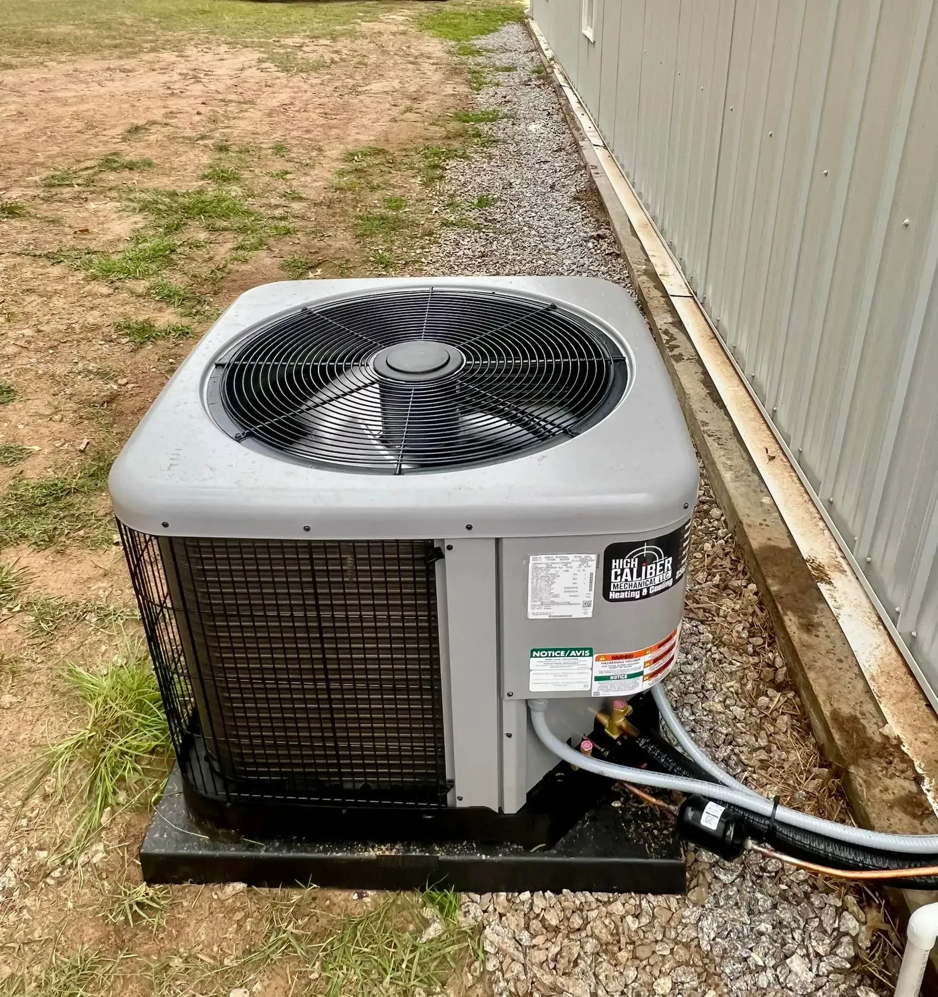An air conditioner is sitting on the side of a building.