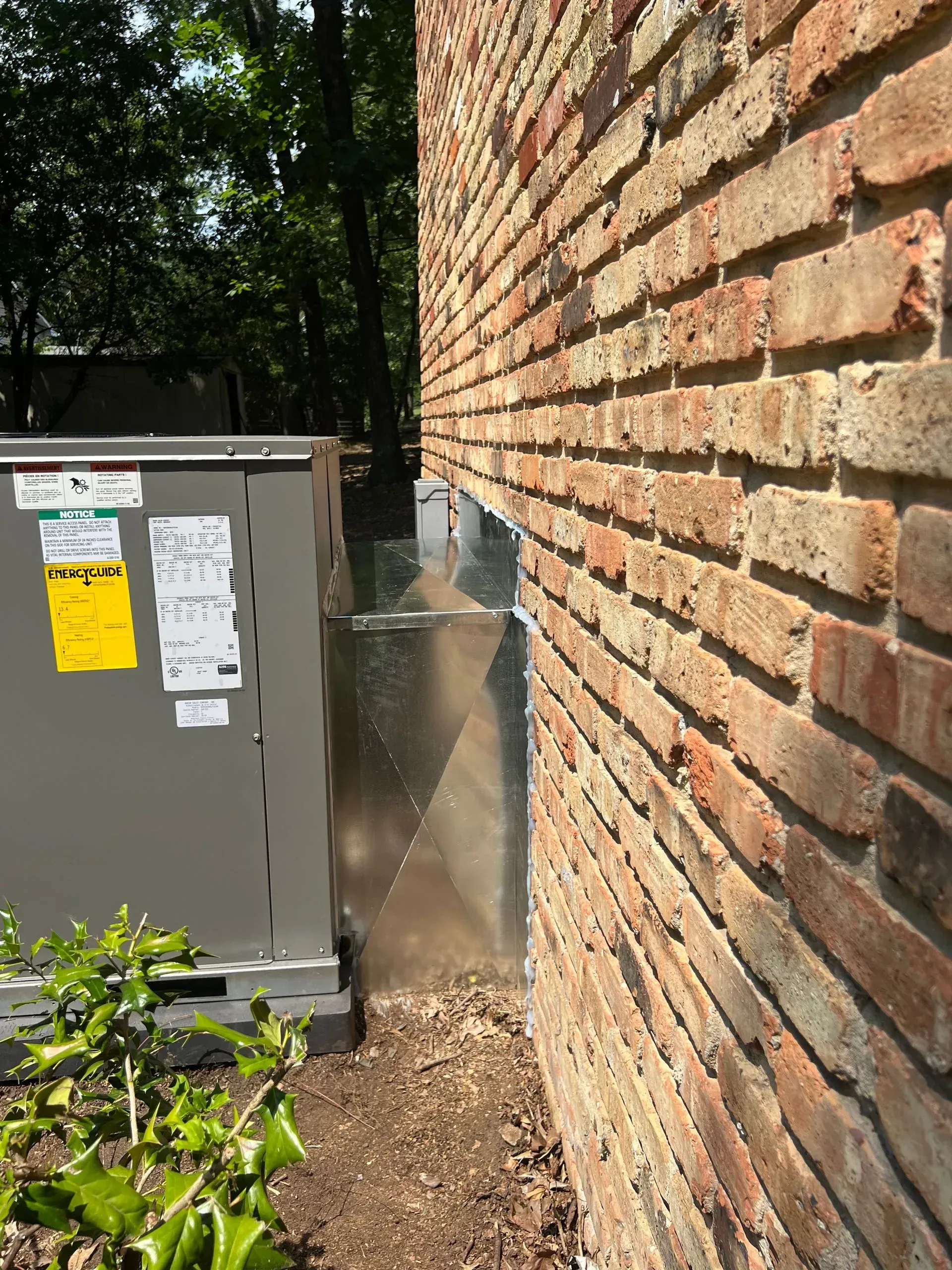 A brick wall with a box on the side of it