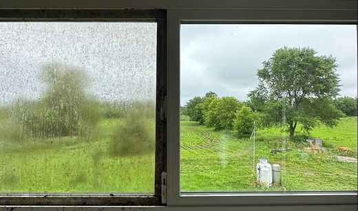 A before and after picture of a window with a view of a field.