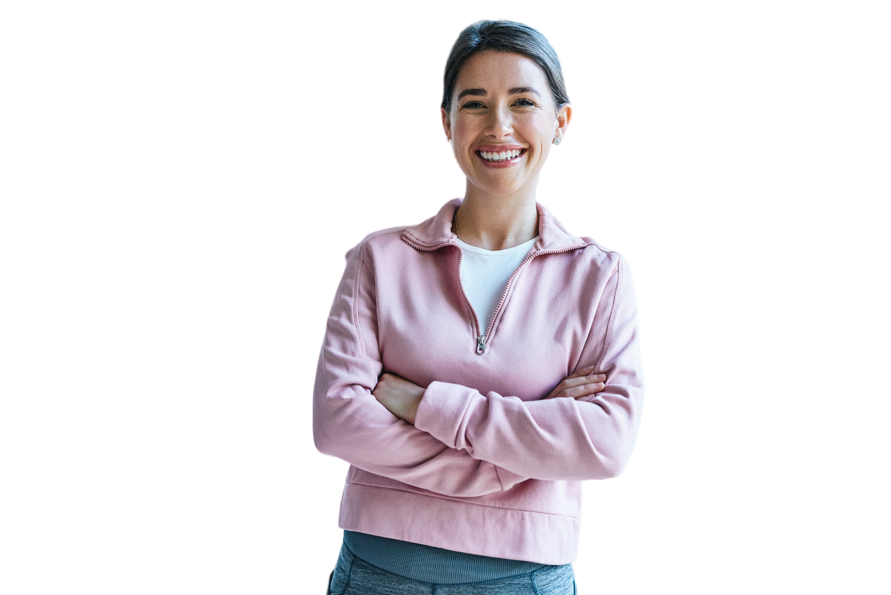 Woman with arms crossed, wearing a pink sweater, and smiling against a white background.