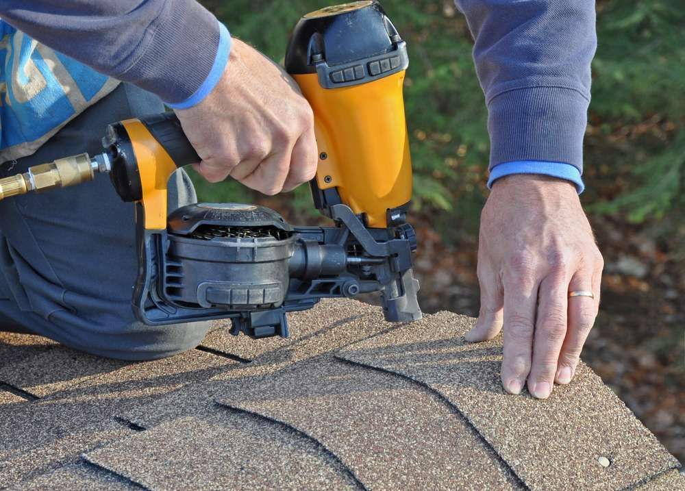 Man installing roof tiles