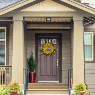 The front door of a house with a wreath on it