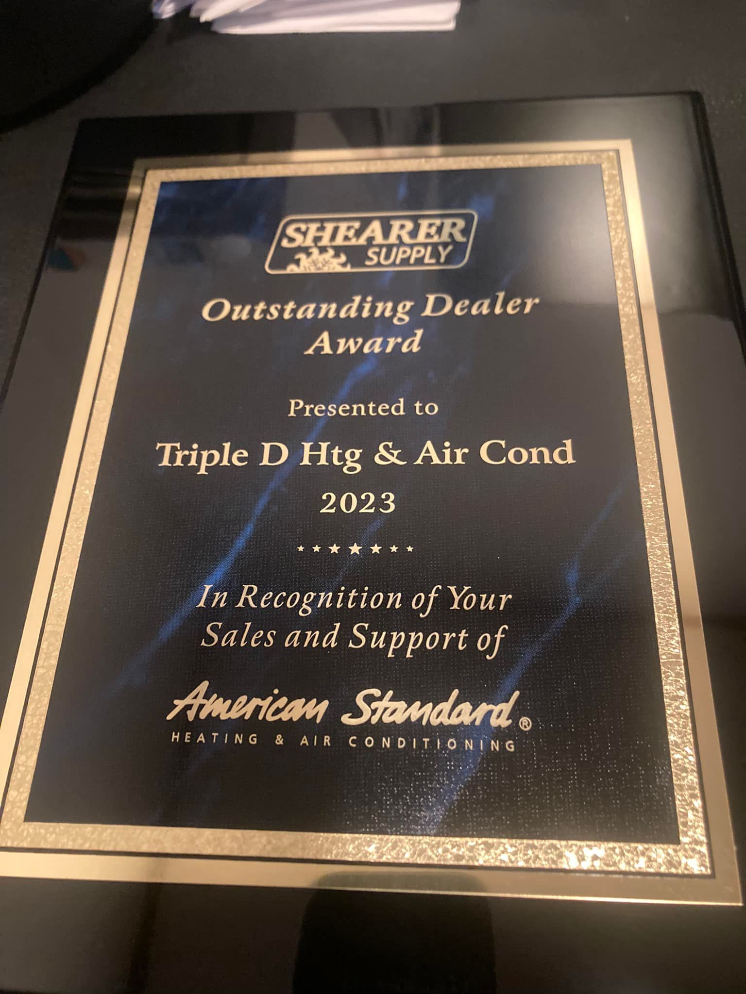 A plaque that says shearer supply outstanding dealer award