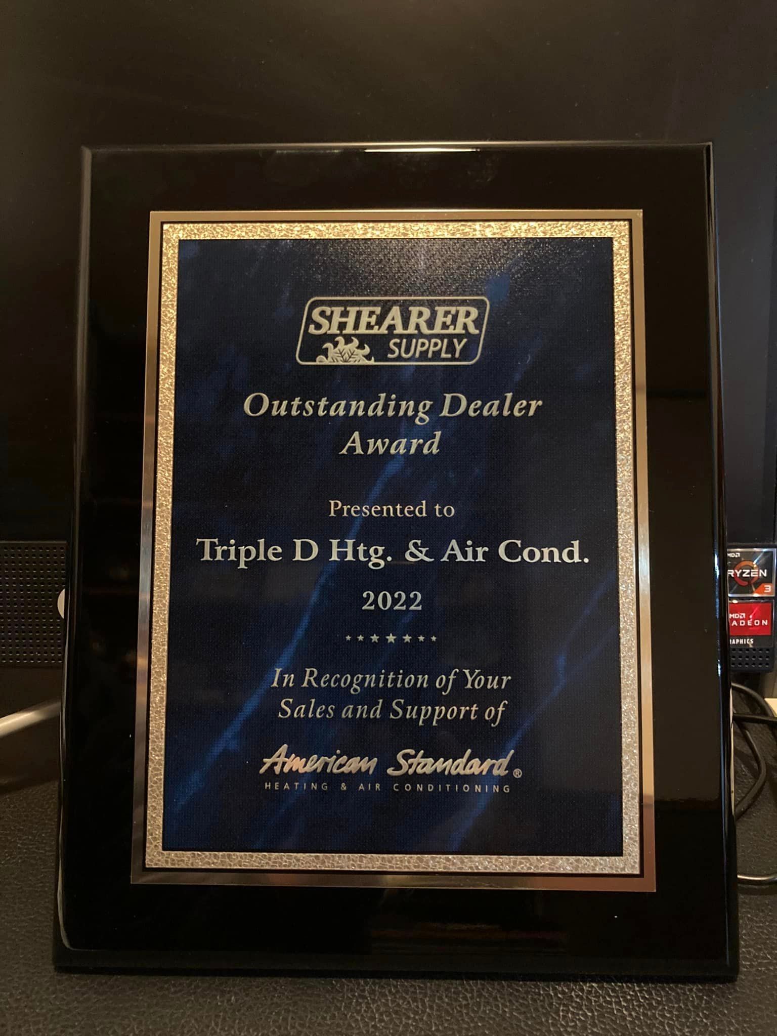A plaque that says outstanding dealer award on it