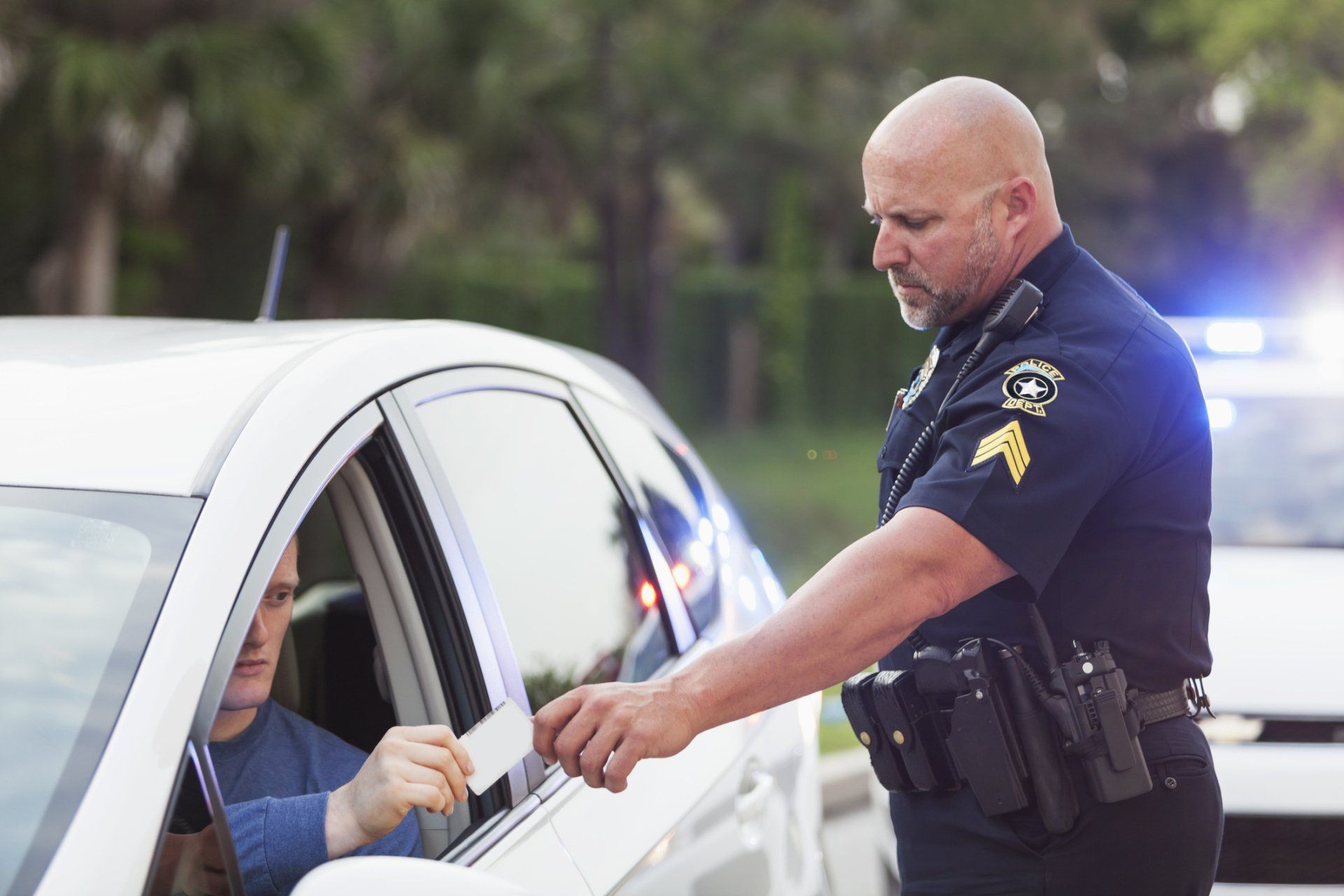 A police officer handing a ticket to a person.