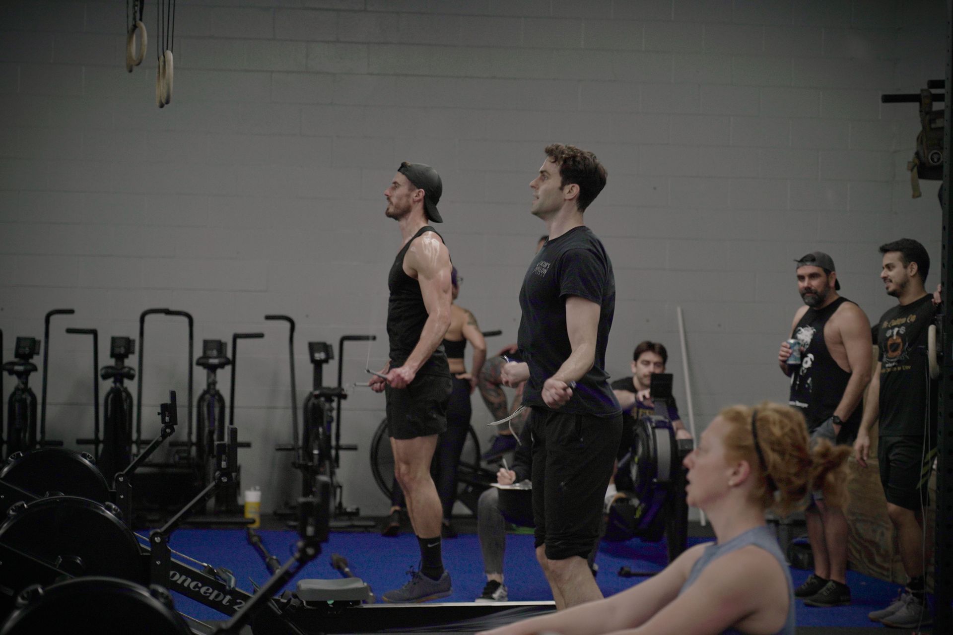 A group of people are doing exercises in a gym.