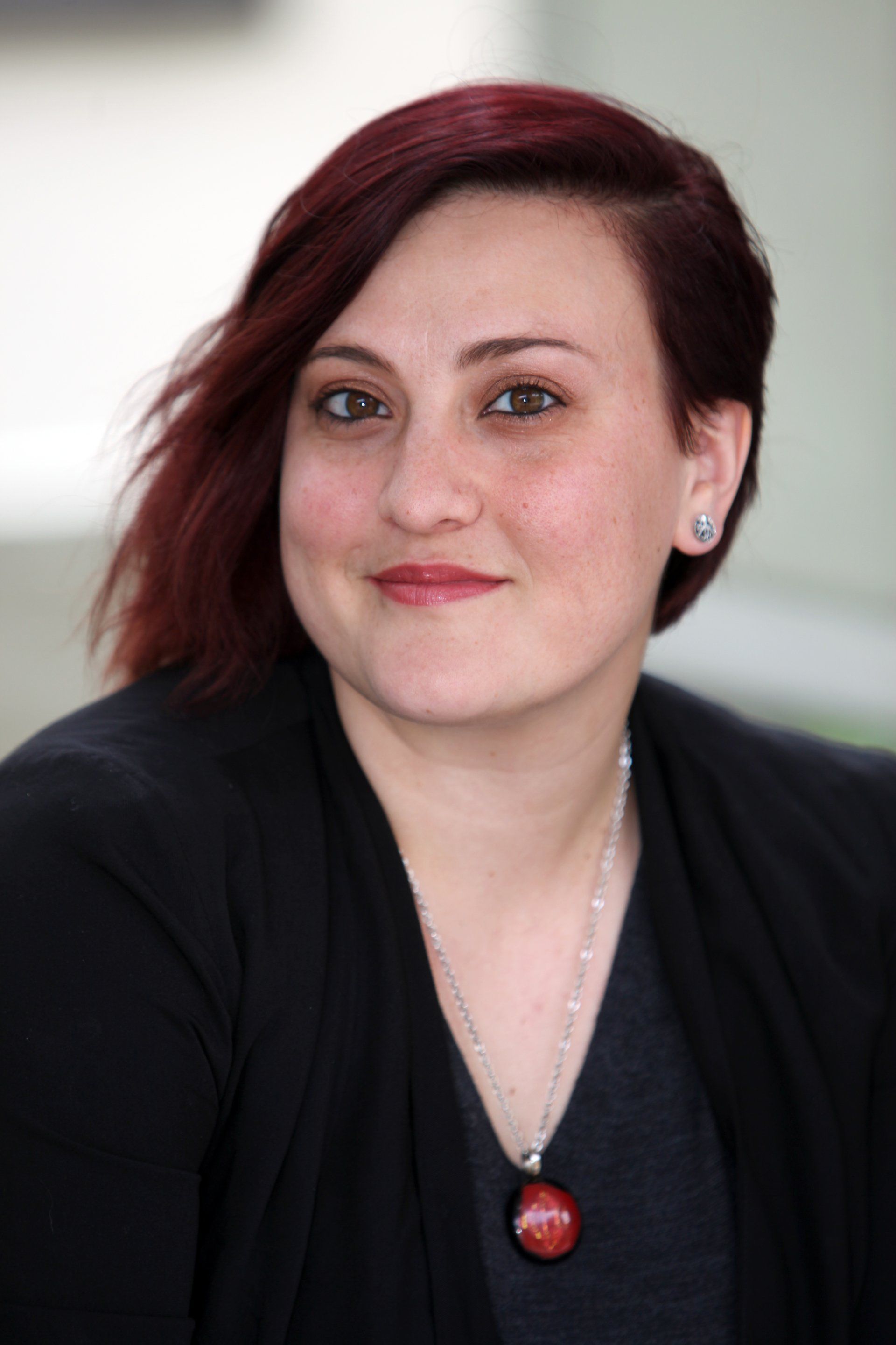 A woman wearing a black sweater and a necklace - Stephanie Del Puerto's Picture