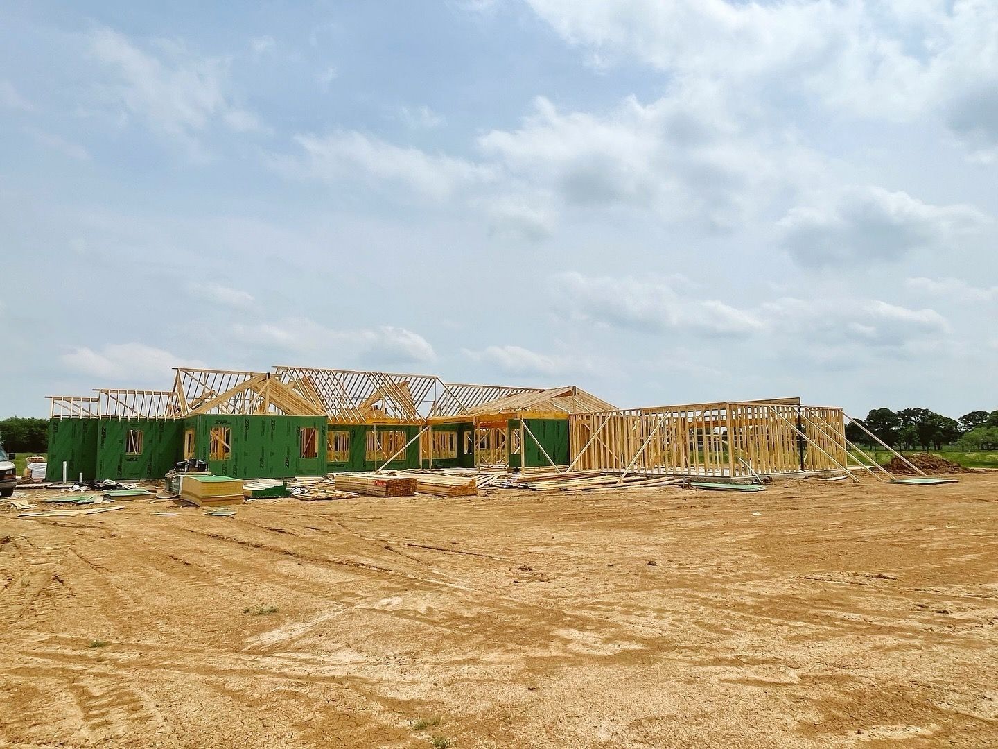 A house is being built in a dirt field.
