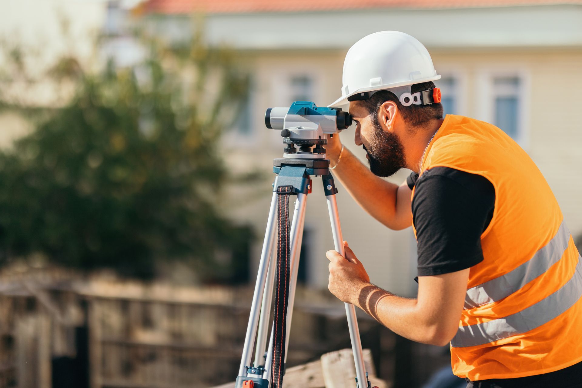 A man is looking through a telescope on a tripod.