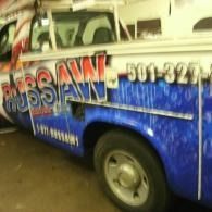 Blue and white service truck with large red lettering parked indoors