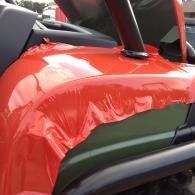 Red cloth draped over a black car seat with a roll bar visible