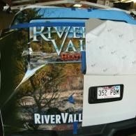 Damaged white car with River Valley decal and license plate 352 PBM