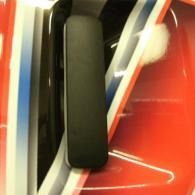 Black rectangular object on a red, white, and blue striped background