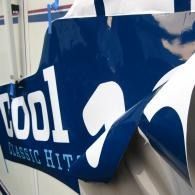 Blue “cool” sign with a white polar bear graphic and “classic city” text, partially crumpled