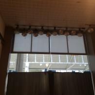 Curtained window with a valance, showing a building outside