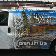 River Valley Air van with mountain scene wrap and website text on the side