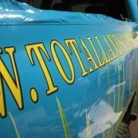 Close-up of a blue banner with large yellow lettering reading “N. TOTALL…”
