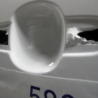 White plastic cap or knob on a bag, with blue “50” visible below.