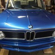 Blue classic BMW car front view in a garage