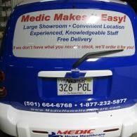 Blue Medic Makes Easy van with rear signs for medical transport and phone numbers