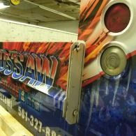 Close-up of a colorful truck side panel with bold graphics and circular tail lights