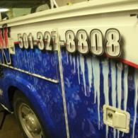 Blue vehicle side with white paint streaks and a large phone number decal reading 501-327-8808