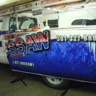 Blue truck sign with phone number in a garage