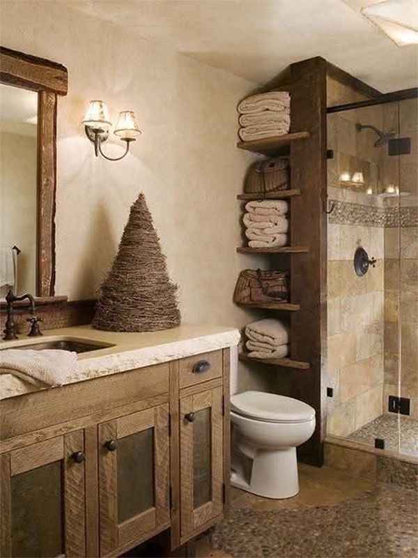 Rustic bathroom with wooden vanity, shelves, and shower. Toilet is in the foreground. Beige and brown tones.