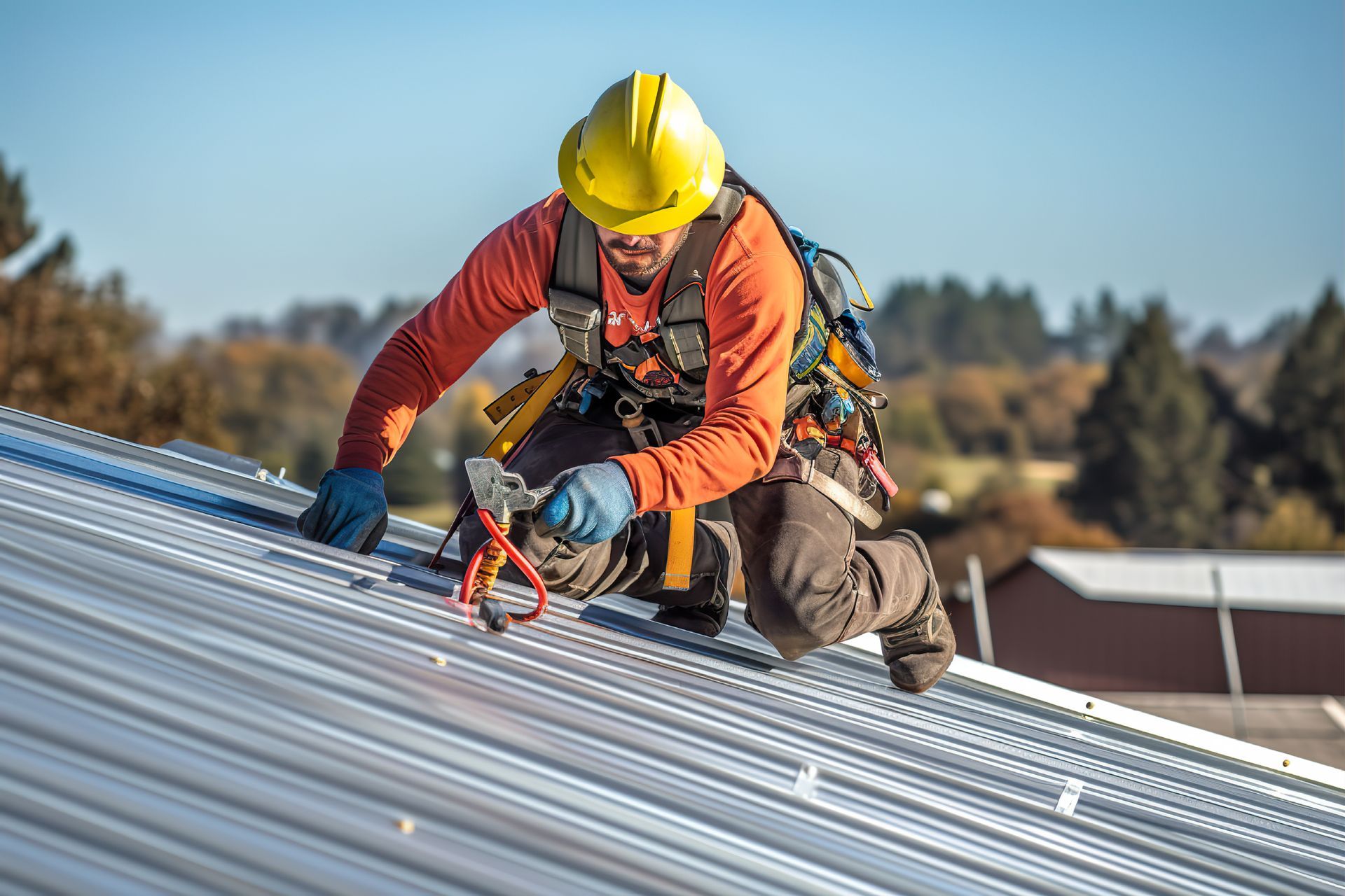A commercial roofing contractor installing a metal roof safely on a commercial building.