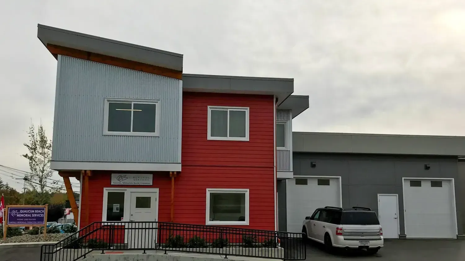 A large white building with a brown roof and a lot of windows.