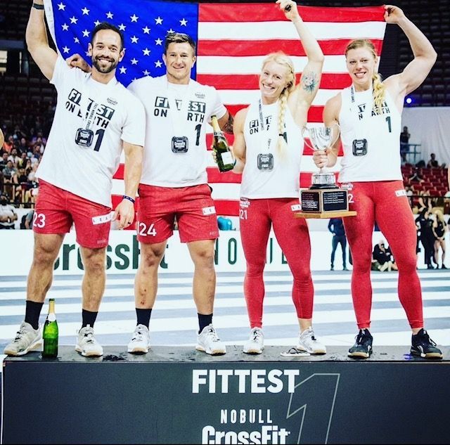 A group of people standing on a podium that says fittest