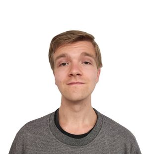 A young man with a beard is wearing a striped shirt.