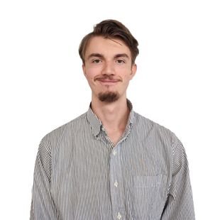 A young man with a beard is wearing a striped shirt.