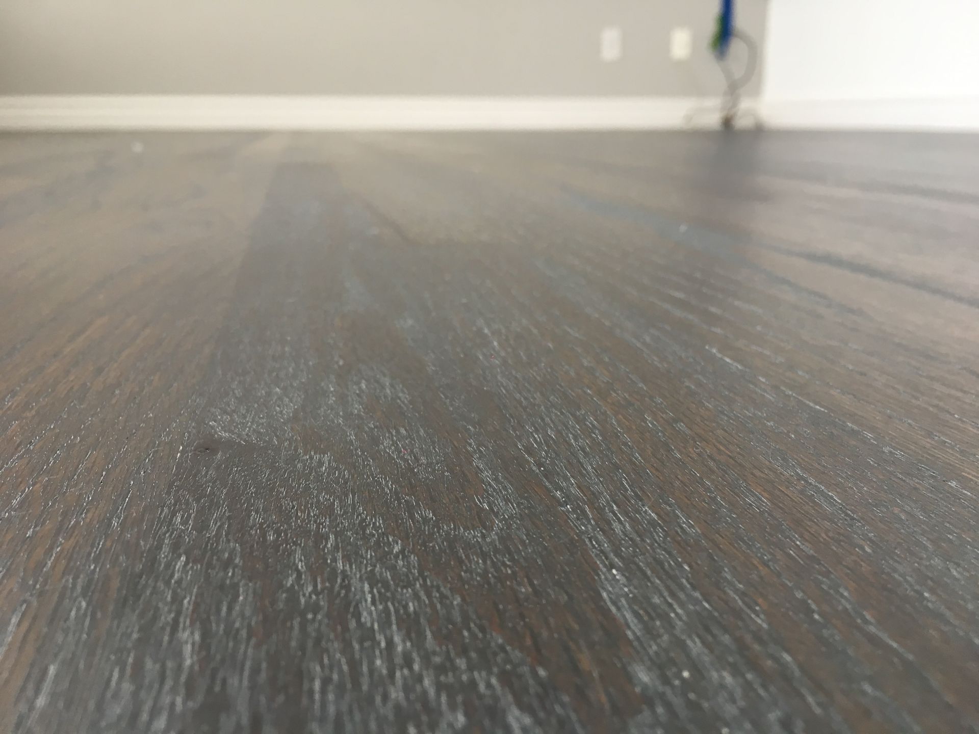 A close up of a wooden floor in a room.