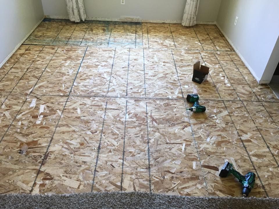 A room with a wooden floor and a drill on it.