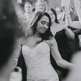 Bride shakes her dark hair while dancing