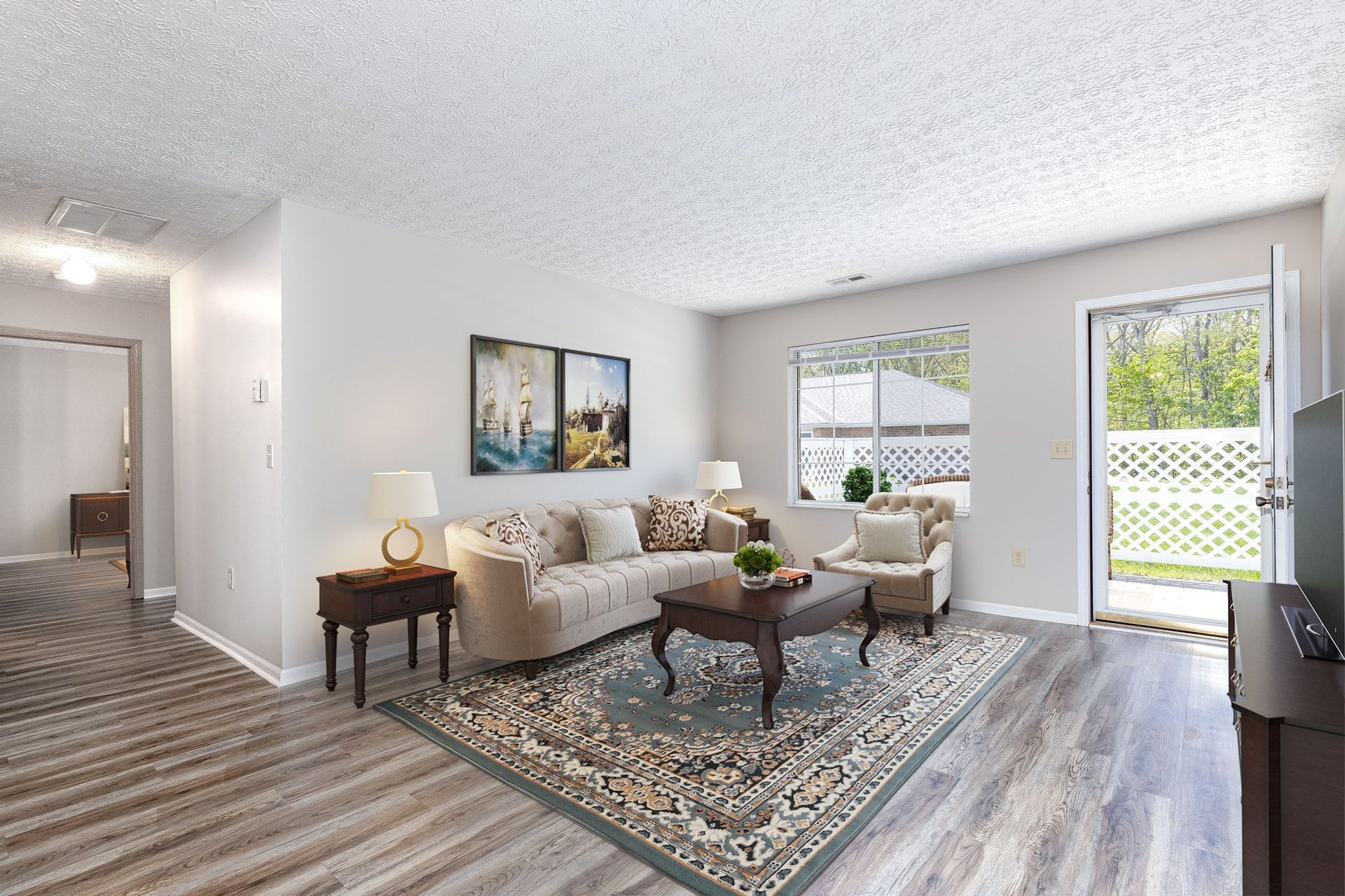 A living room with a couch , coffee table , and rug.