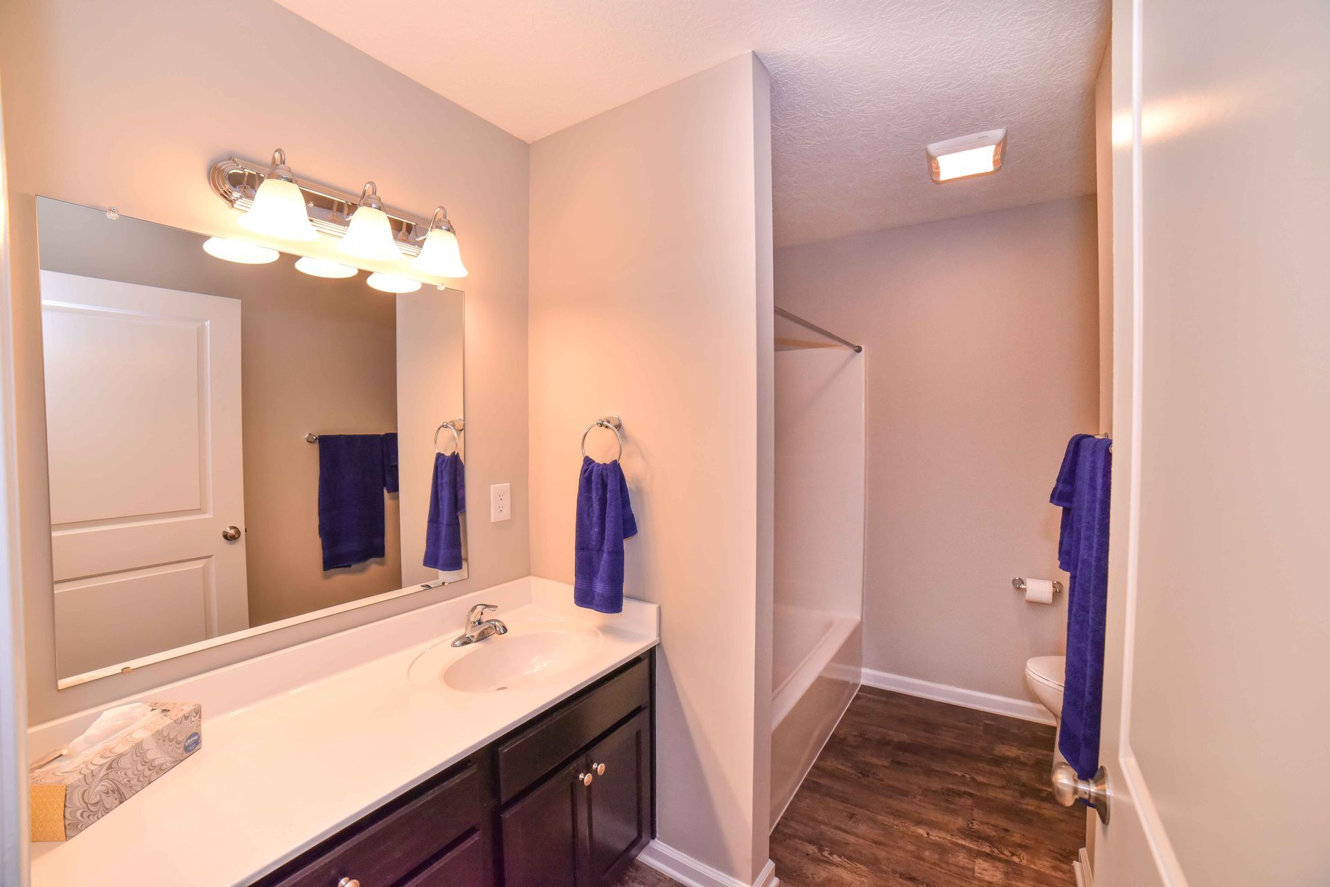 A bathroom with a sink , toilet , and mirror.