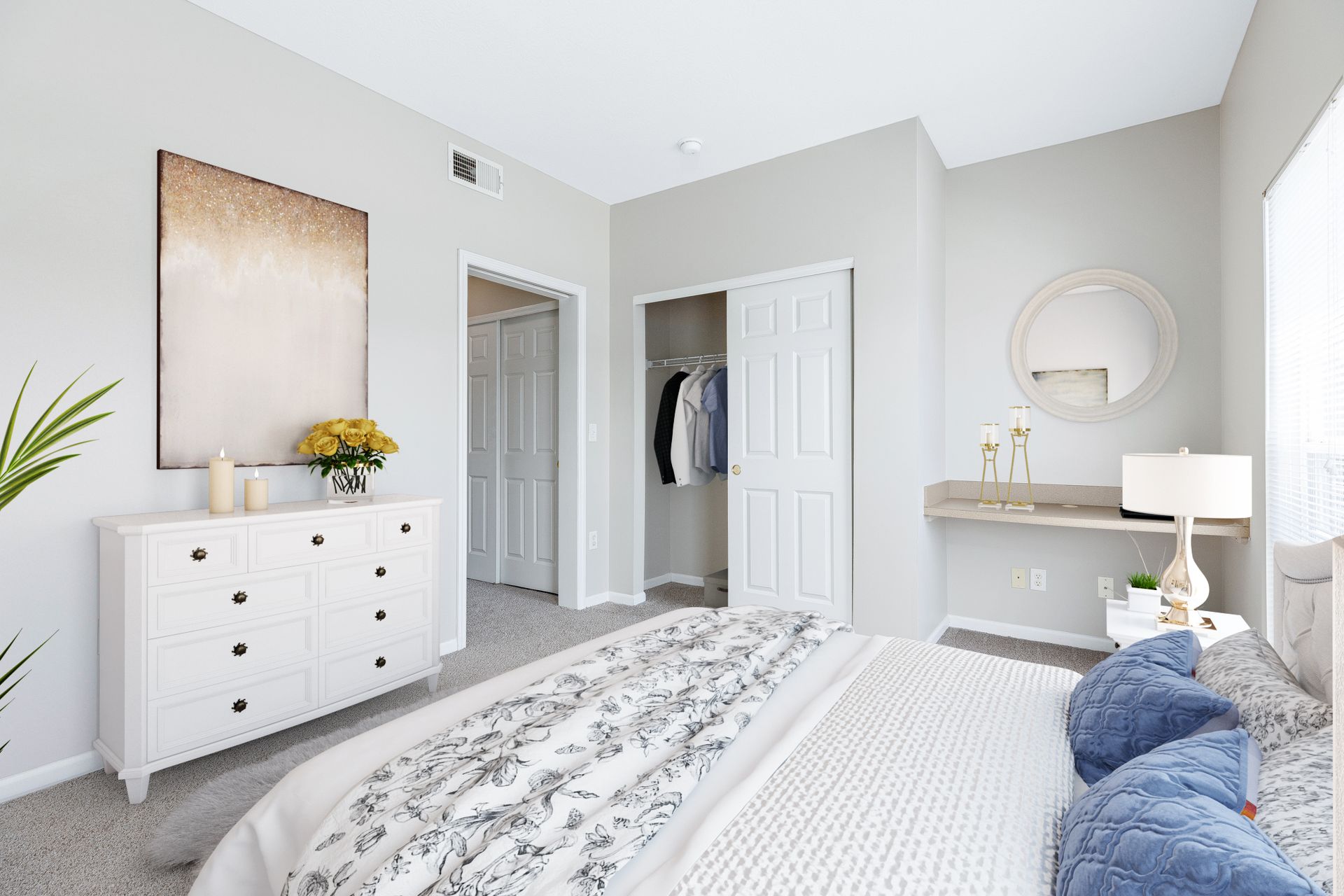 A bedroom with a bed , dresser , mirror and closet.