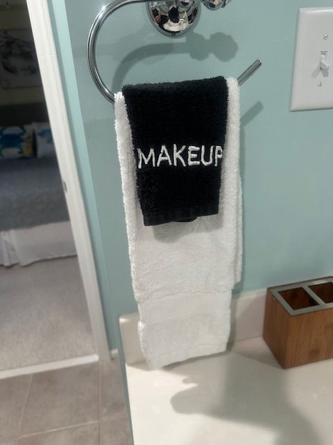 A white and black towel labeled 