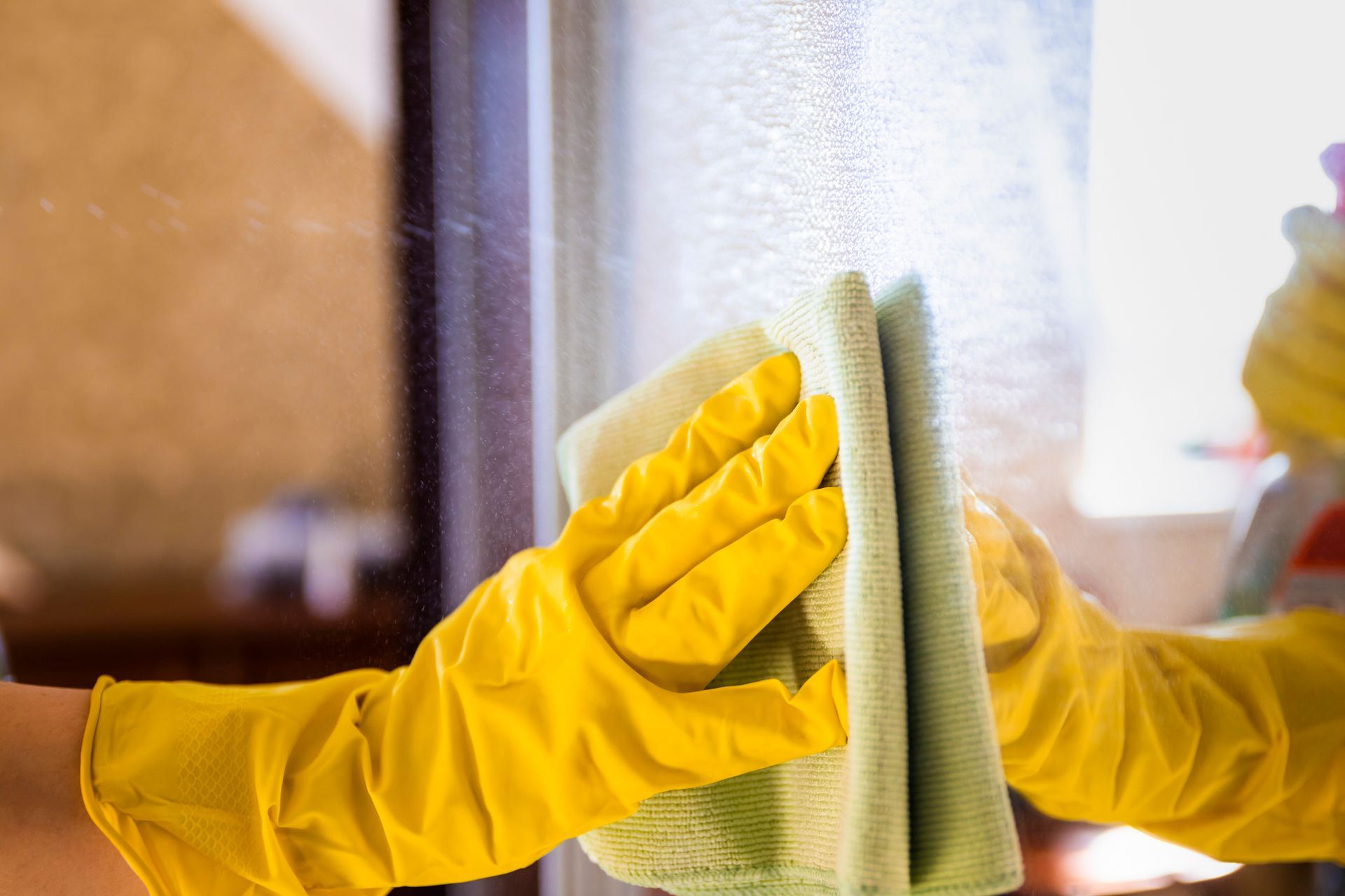 A Person Is Cleaning a Window — Houston, TX — ACC Cleaning Services LLC