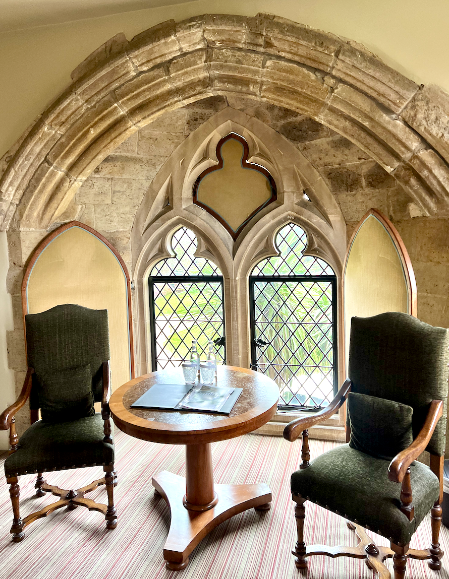 Arched castle window with shaped shutters