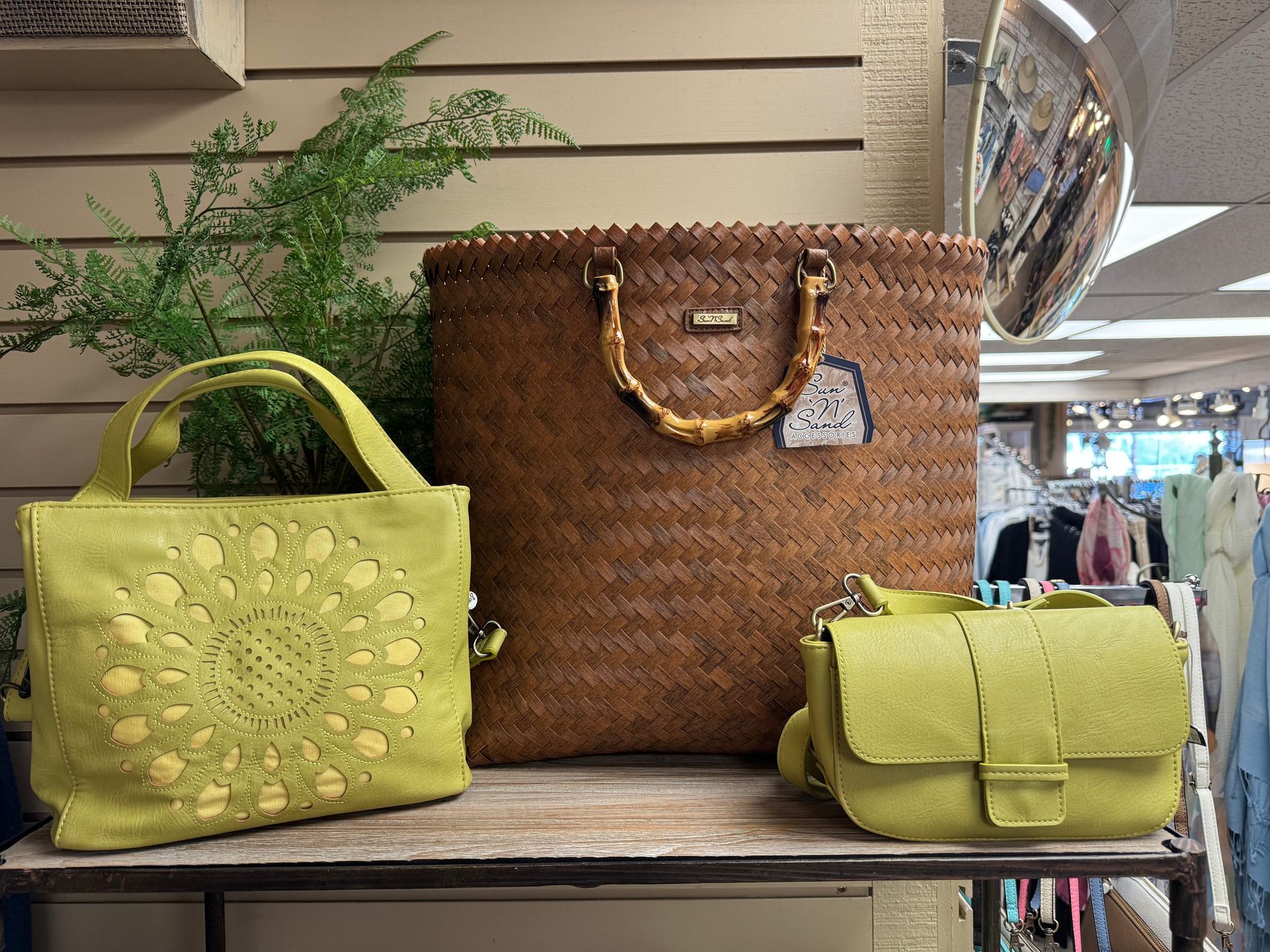 Three bags are sitting on a table in a store.