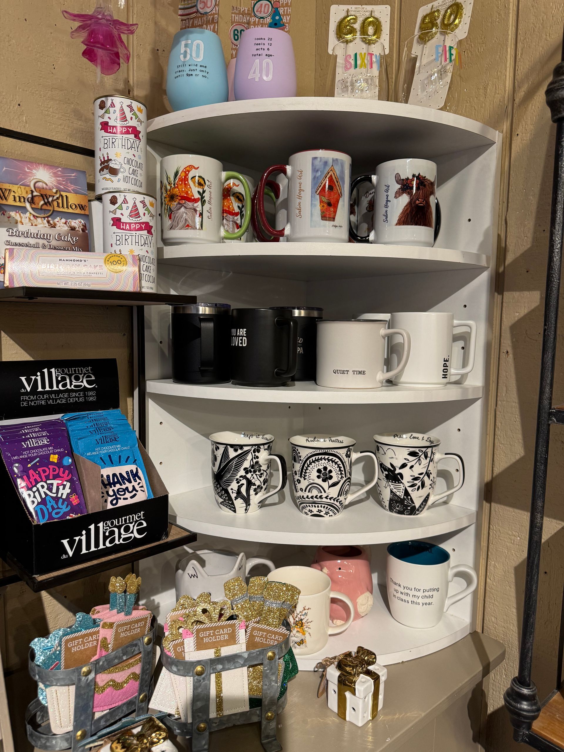 A shelf filled with lots of different types of mugs.