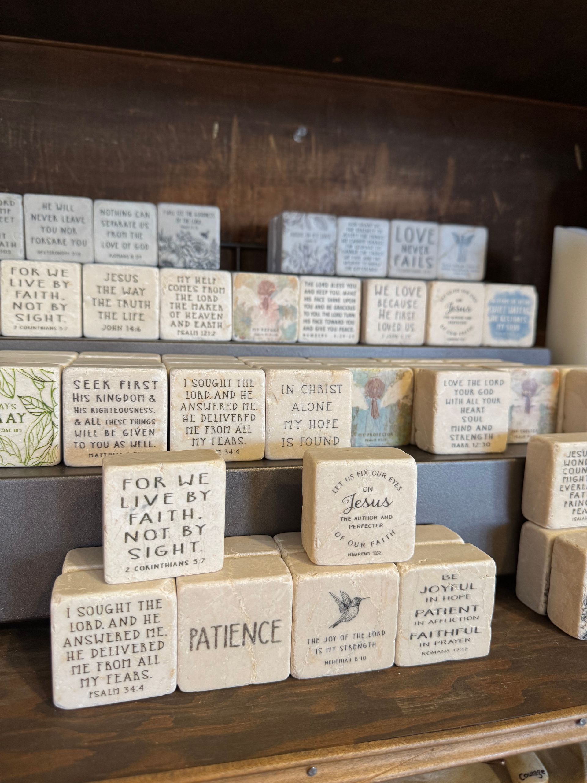 A shelf full of soaps with one that says patience