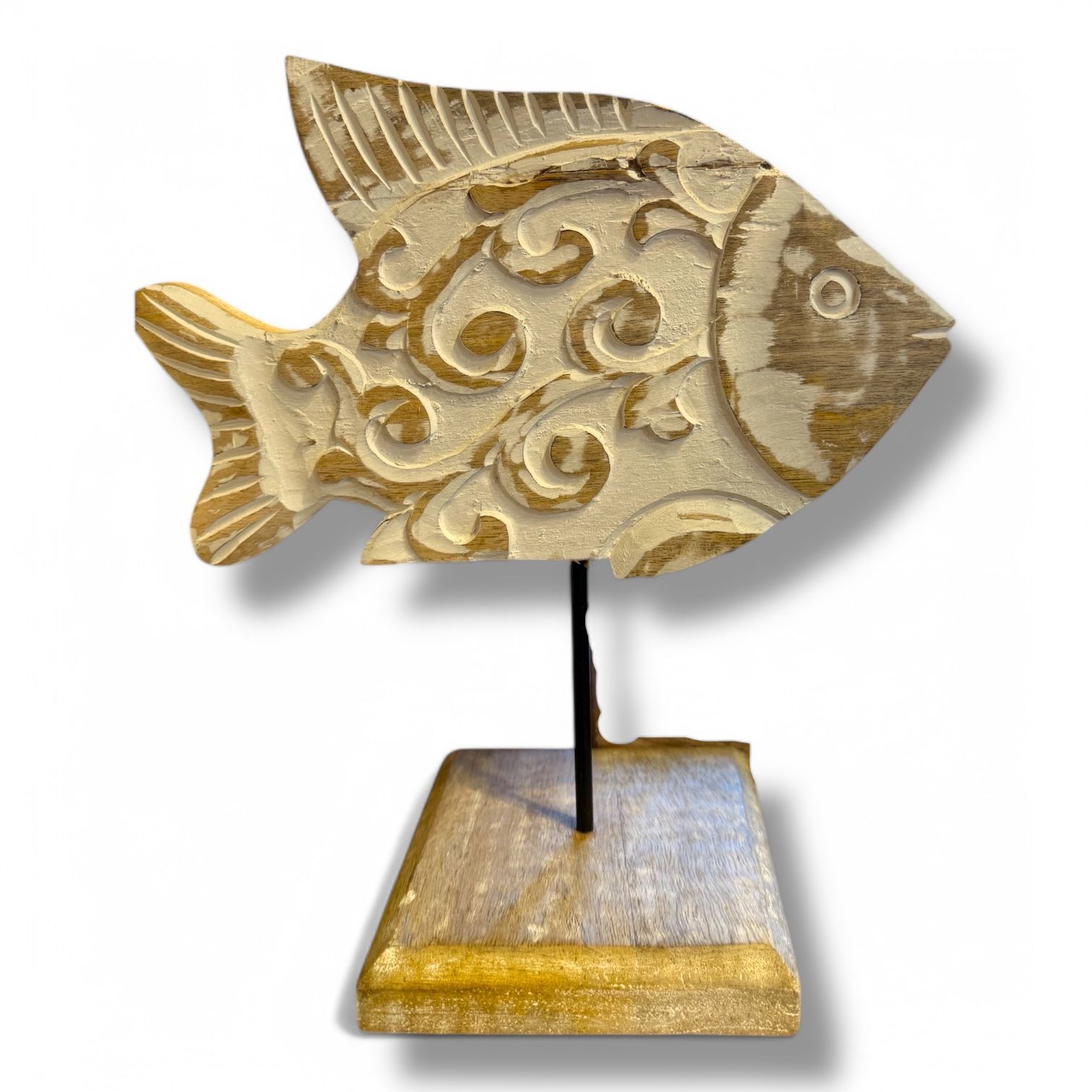 A carved wooden fish on a metal stand