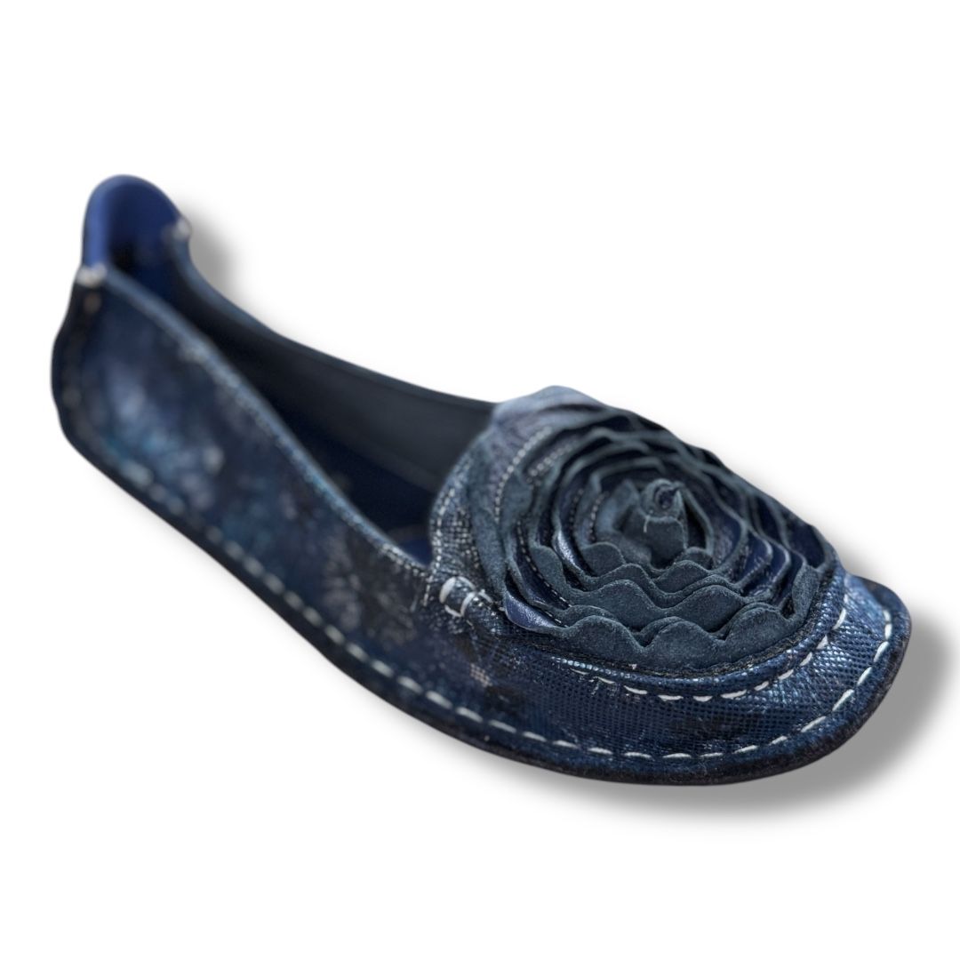 A pair of blue shoes with a flower on the side