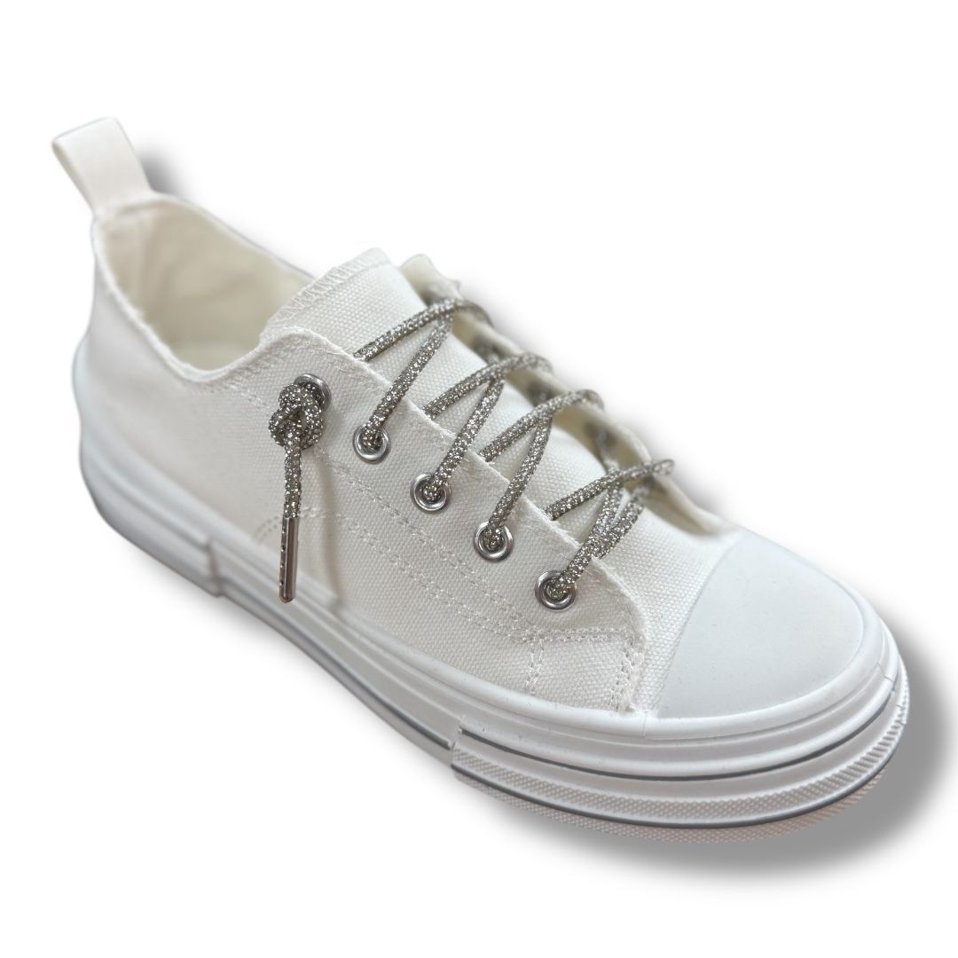 A pair of white sneakers with silver laces on a white background